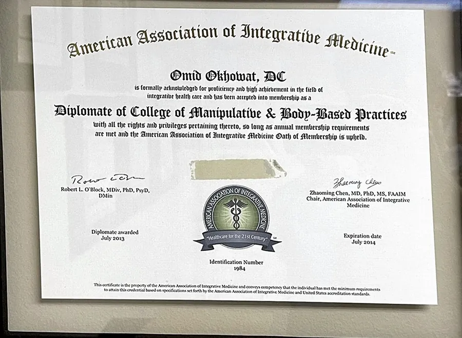 Framed certificate naming Omid Okhowat, DC a Diplomate of the College of Manipulative and Body Based Practices, American Association of Integrative Medicine